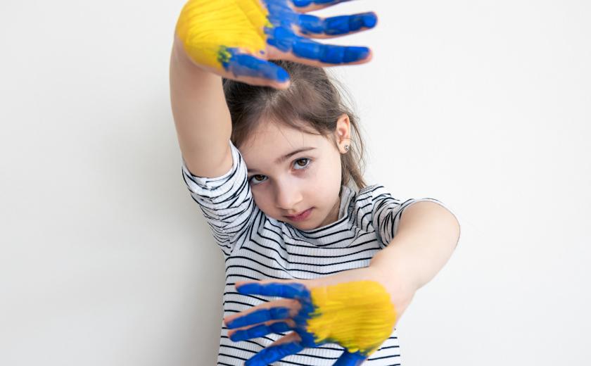 kind met verf op handen